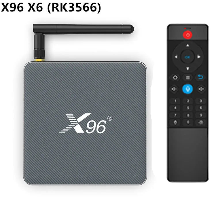 Android smart TV set-top box with voice control remote on a table next to a television.