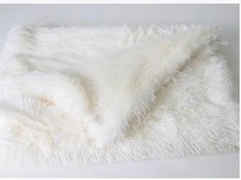 Soft long plush dog blanket in dark grey, sizes S M L shown next to a large dog.