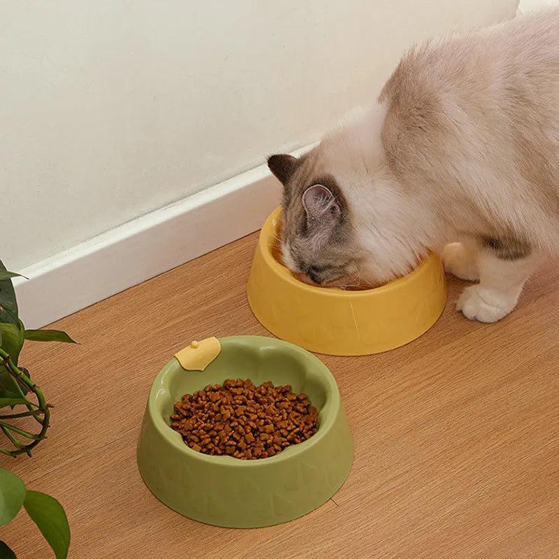 Green plastic pet bowl with dual compartments for food and water, anti-tipping design