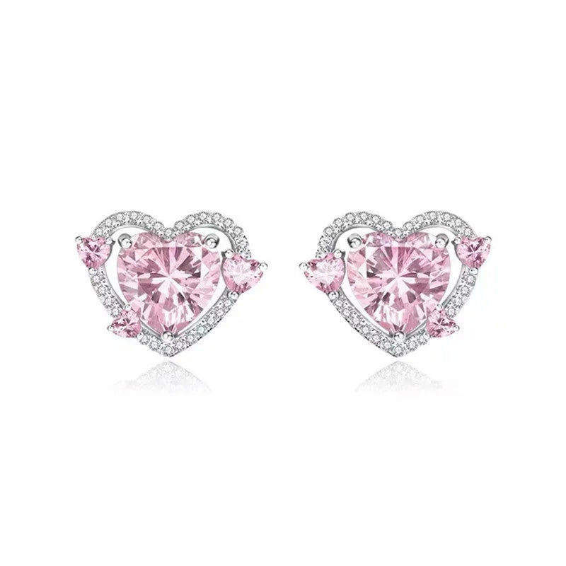 A pair of women's heart-shaped stud earrings with a white K electroplated finish on a copper base.
