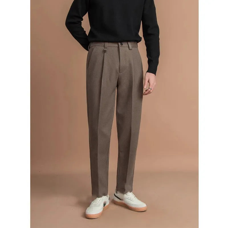 Men's straight-leg casual trousers in black, shown in a light business style setting.