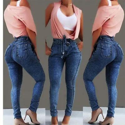 A pair of distressed grey fringed jeans made from Cowboy denim fabric on a neutral background.
