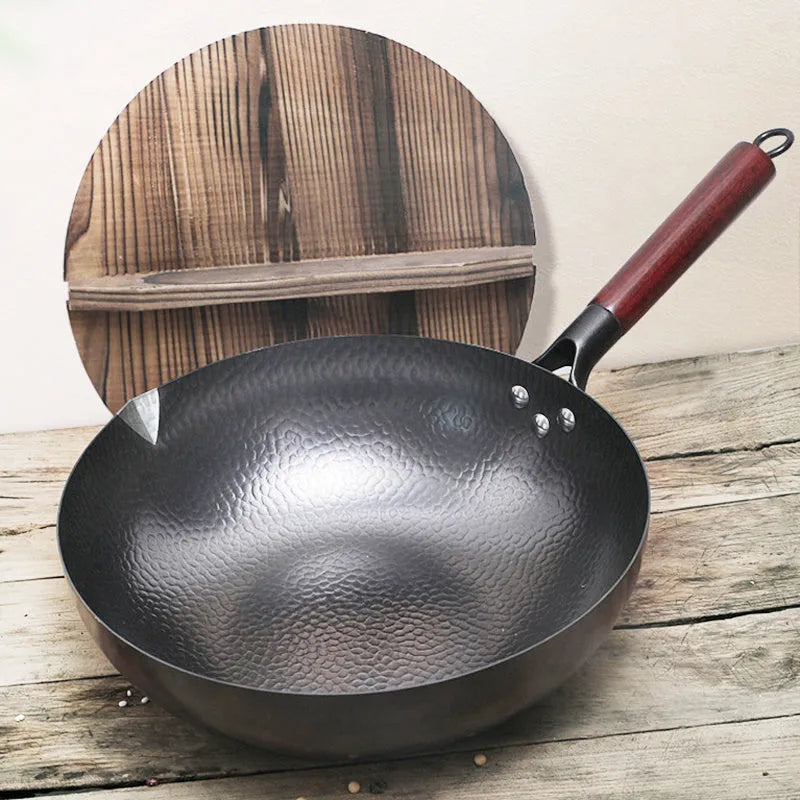 Traditional handmade iron wok pan with wooden handle and black finish, 40cm diameter