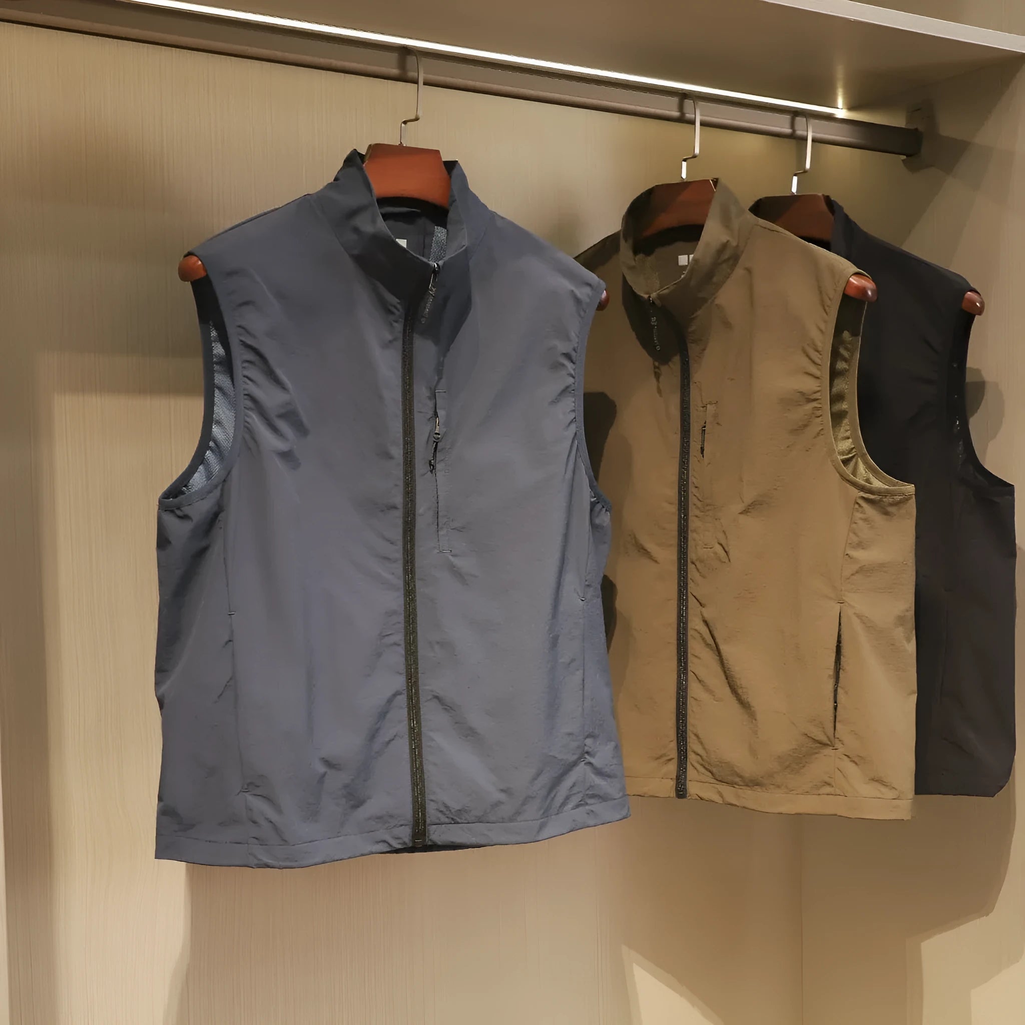 Men's straight-cut nylon vest cardigan in army green with side seam pockets, shown open as a lightweight layer.