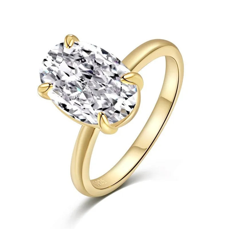 Women's oval 9K silver ring with a four-prong setting, shown in gold and silver tone finishes.