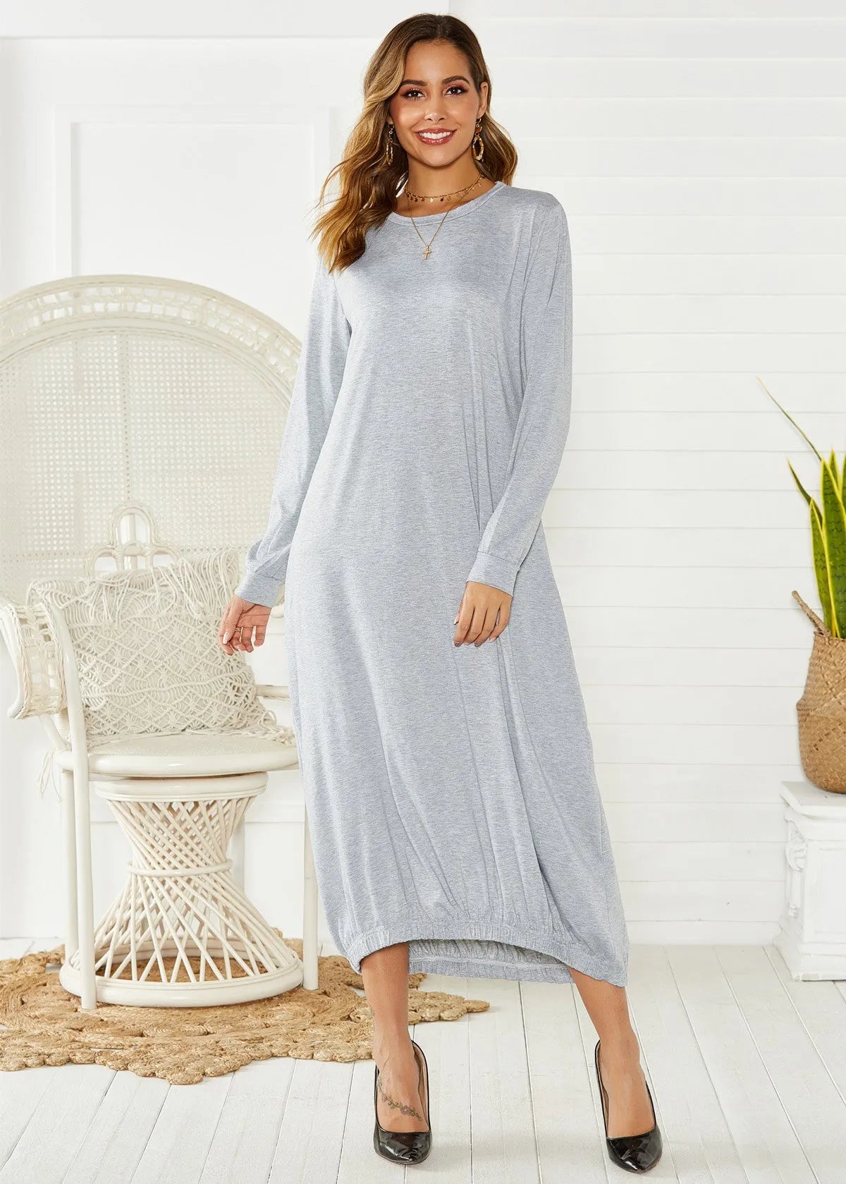 Black lace-up crew neck long lantern dress on a hanger, showing loose fit and lace detail.