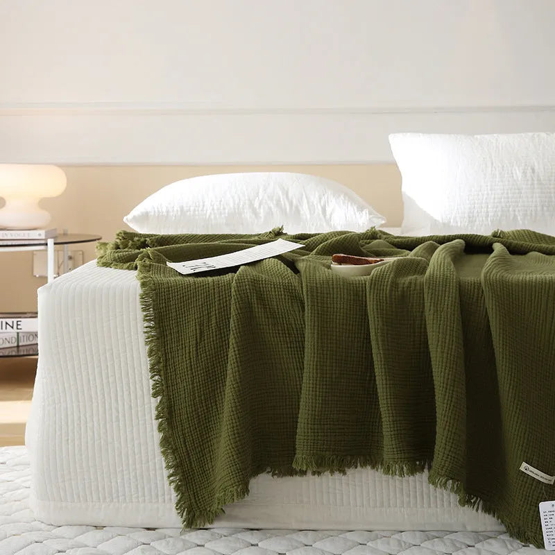 Cotton four-layer gauze blanket with tassel trim in a choice of ten colours and two sizes.