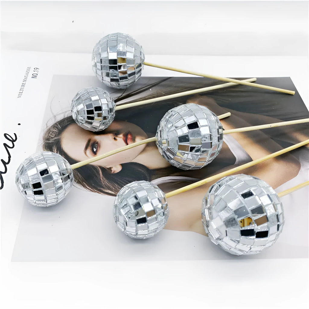 Glass disco ball cake decoration with wooden stick, shown in various sizes from 2.5cm to 5cm.