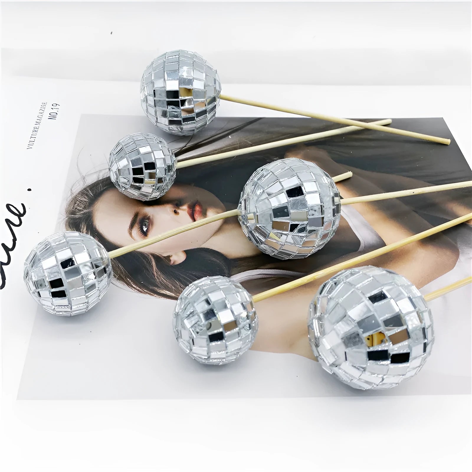 Glass disco ball cake decoration with wooden stick, shown in various sizes from 2.5cm to 5cm.