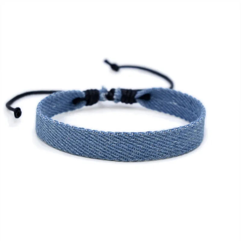 Denim fabric bracelet carrying strap with mixed materials and unisex design