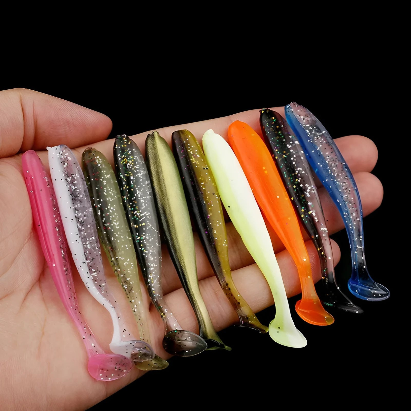 Close-up of a two-tone T-tail soft plastic fishing lure measuring 7cm, shown in a vibrant colour pattern.