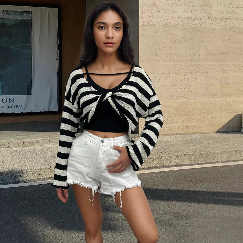 Women's black and white striped long-sleeved sweater with exposed navel front and back design.