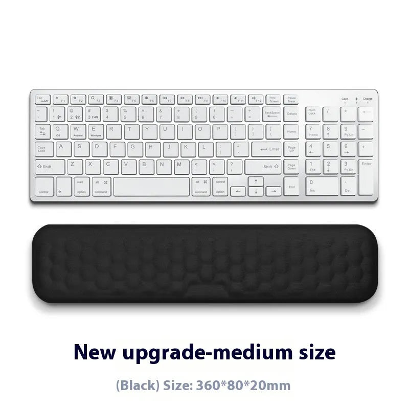 Memory foam mouse wrist pad with silicone bottom in black cloth cover on computer desk