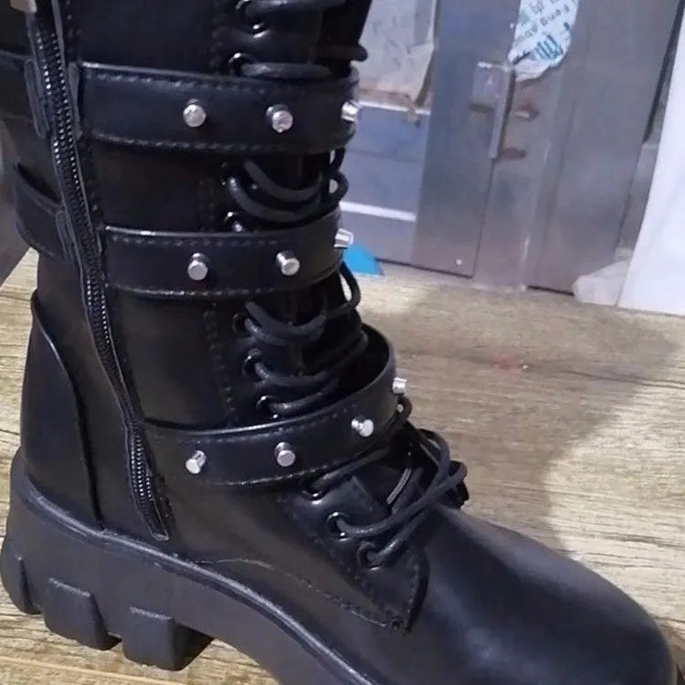 Women's black mid-calf knight boots with a large metal buckle and side zip fastening
