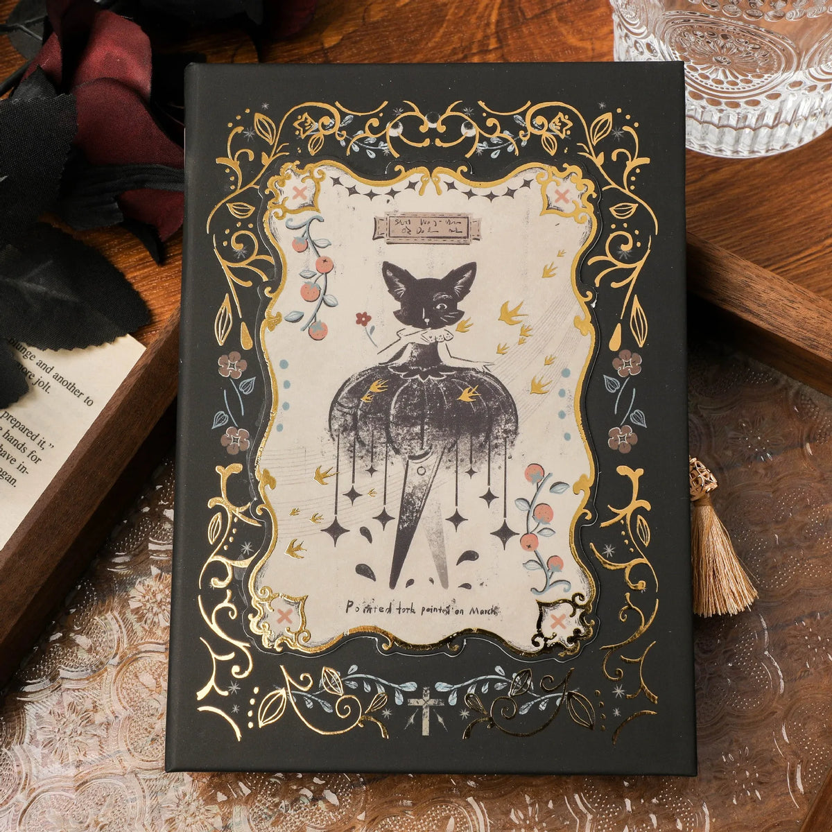 Retro gothic style A5 notebook open on a table, showing detailed cover art and wood pulp paper pages.