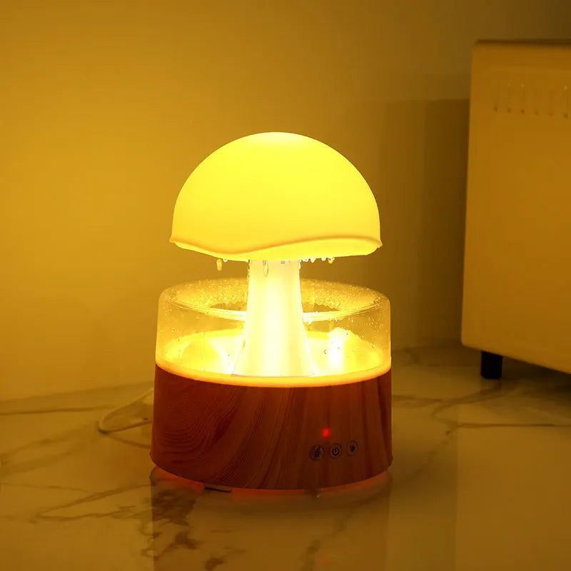 White cloud-shaped humidifier emitting mist with multi-coloured lighting and remote control