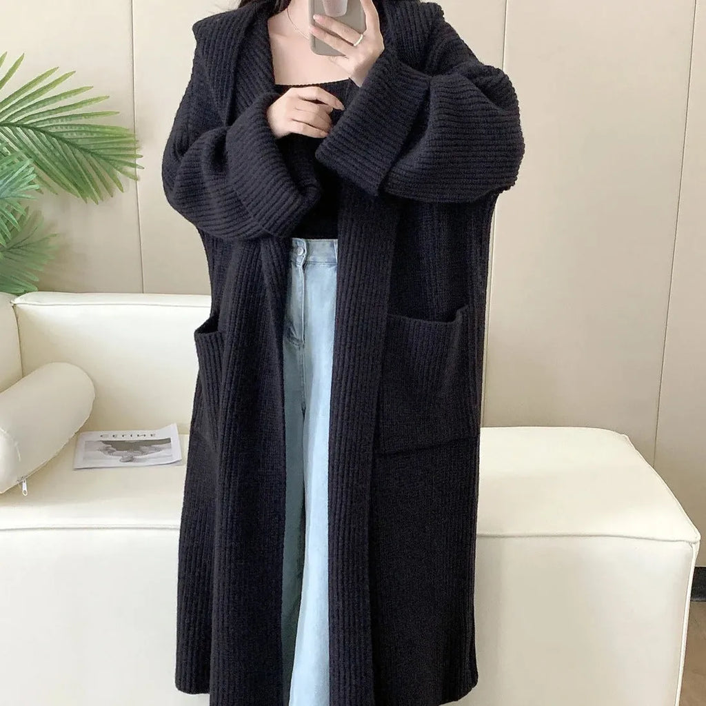 Loose hooded cardigan coat with raglan sleeves in acrylic fabric showing extended length