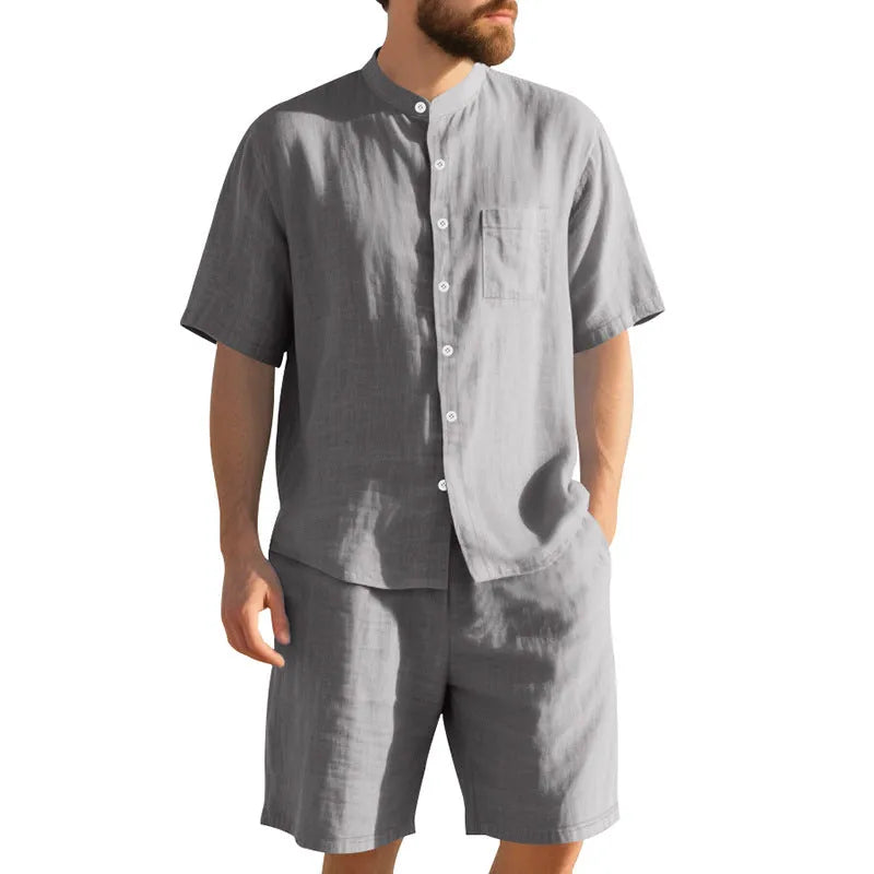 Men's light blue linen two-piece suit with short-sleeved henry collar shirt jacket and shorts on a hanger.