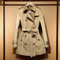Khaki double-breasted women's trench coat with long flight sleeves and button front.
