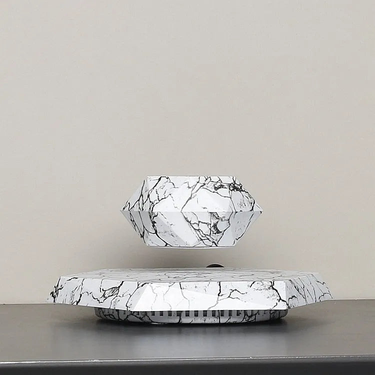 Marble colour magnetic levitating plant pot floating and rotating a small bonsai plant