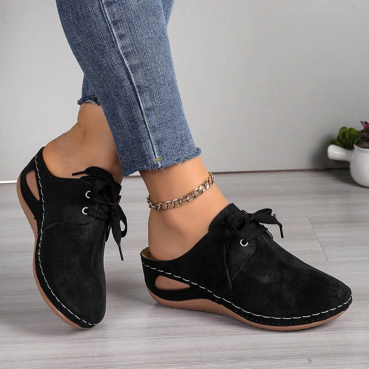 Women's suede lace-up wedge slippers in light grey, showing hollow-out design and rubber sole.