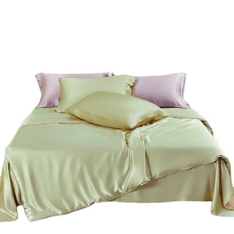 Solid colour silk duvet cover shown in Lotus Pink, laid flat on a bed.