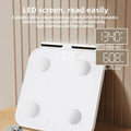 White professional body fat scale with 8 metal electrodes and a clear LED display on a tempered glass platform.
