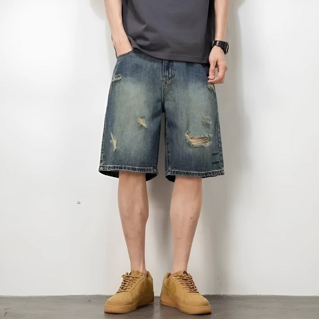 Blue retro loose hole men's denim shorts with a straight cut, shown on a model.