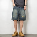 Blue retro loose hole men's denim shorts with a straight cut, shown on a model.