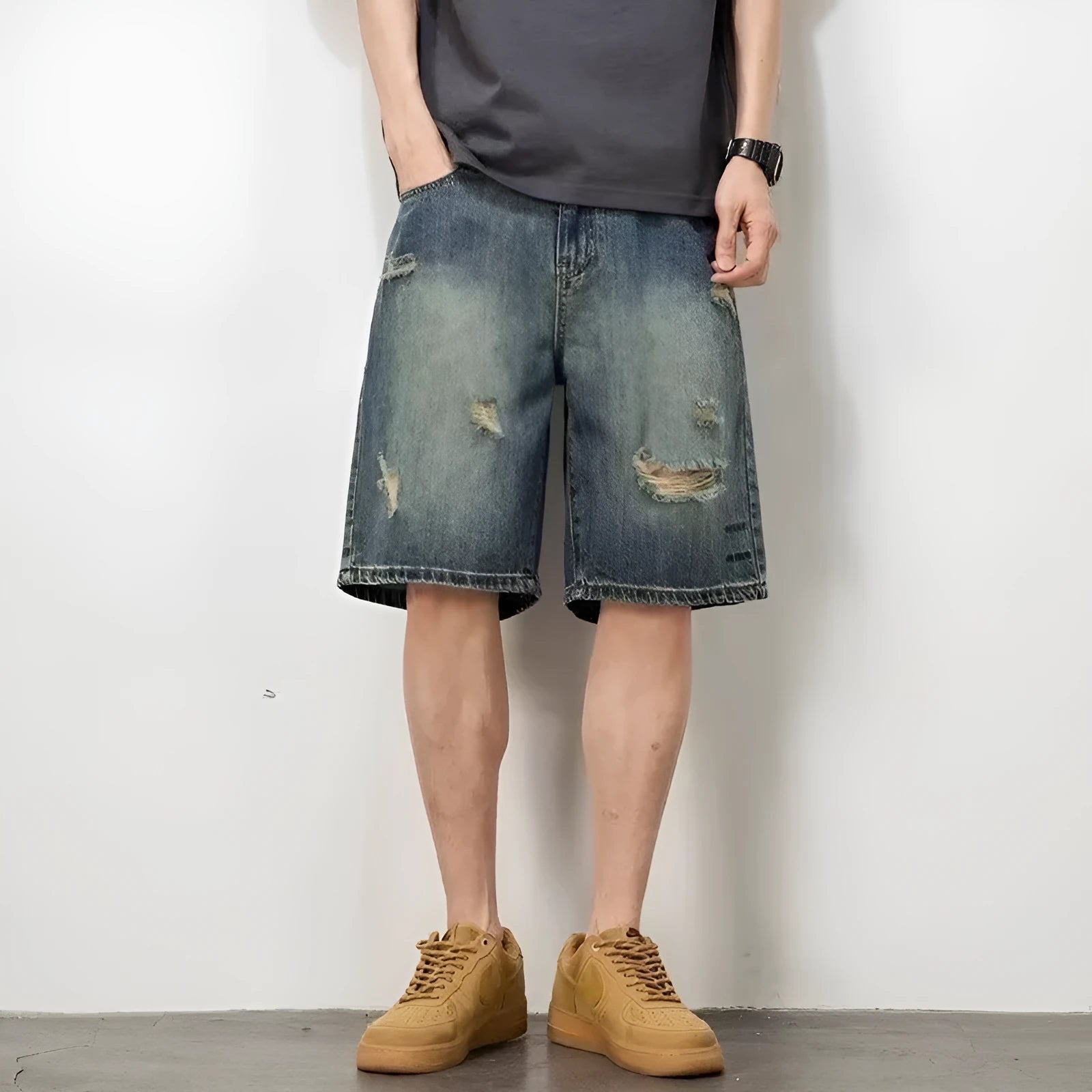Blue retro loose hole men's denim shorts with a straight cut, shown on a model.