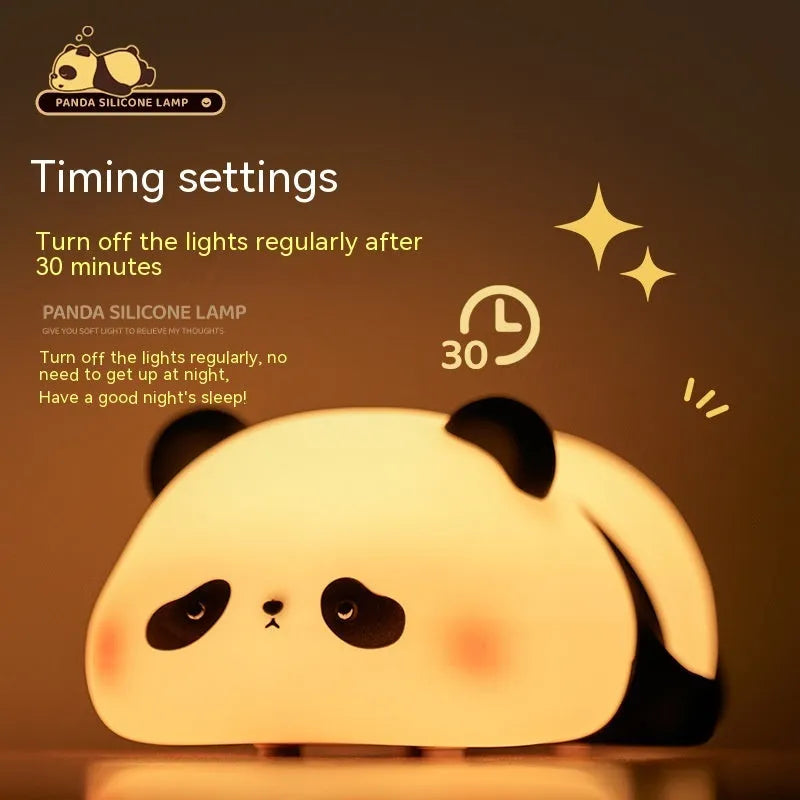 Cute cartoon panda-shaped silicone night light for children on a bedside table.