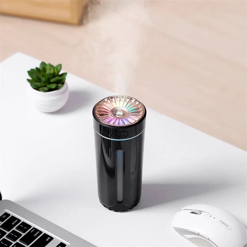 Black portable USB humidifier with colourful LED lights, shown next to a USB cable, suitable for car cup holders.