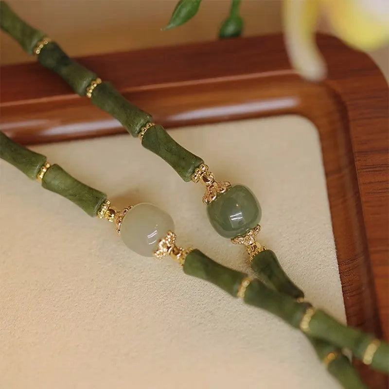 Dark green Hetian jade bracelet with geometric bamboo festival design on wrist