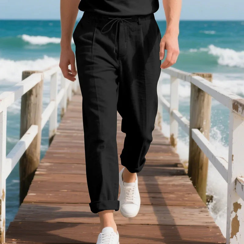 Men's casual linen trousers in a straight leg cut with a drawstring waist, shown in a light colour.