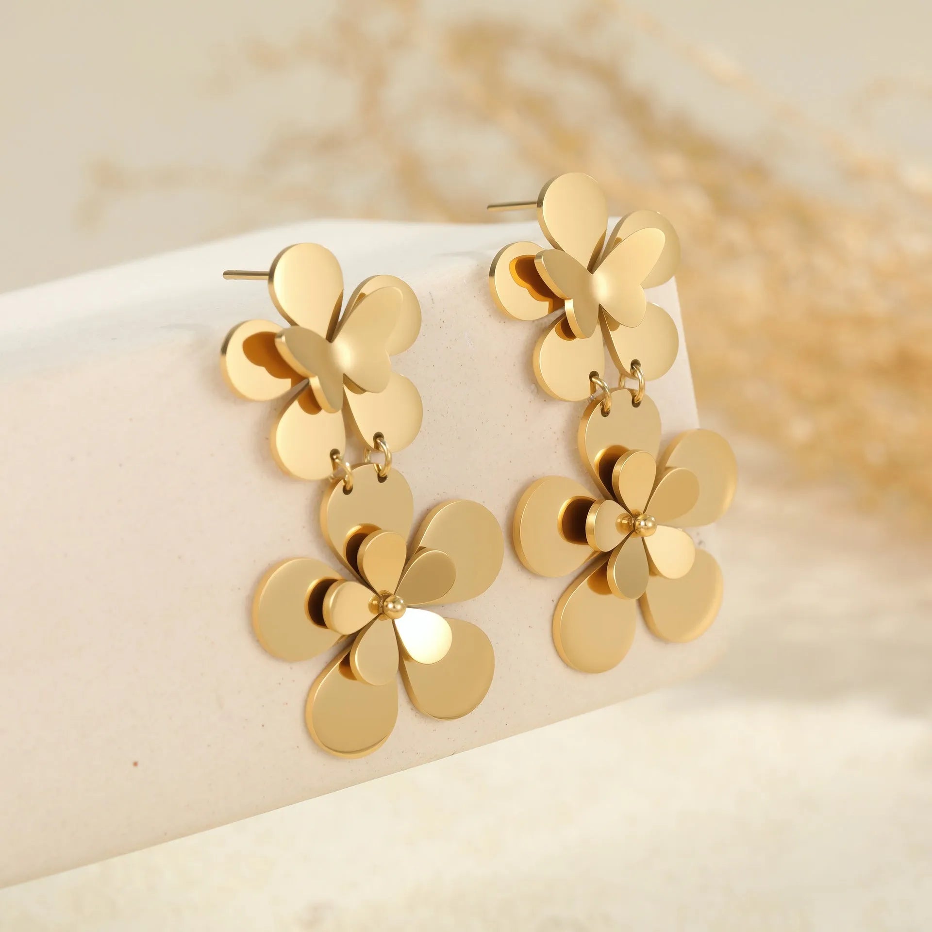 Women's stainless steel earrings with gold electroplated finish and floral butterfly design