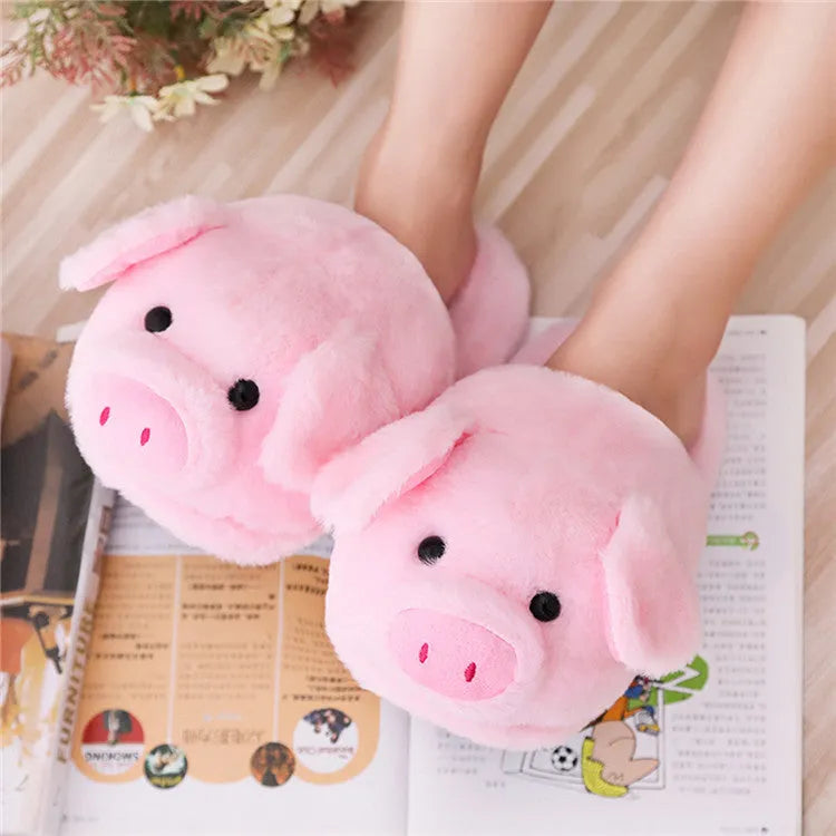 Pink plush floor slippers with a cute pig design on the upper, shown from a side view.