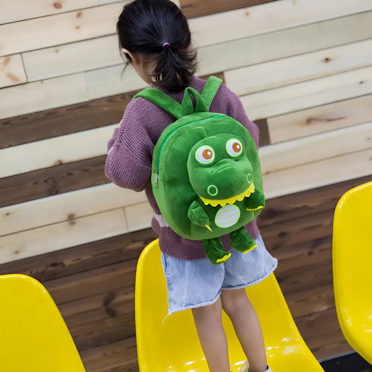 Soft plush dinosaur backpack for children with embroidery detailing and soft handle