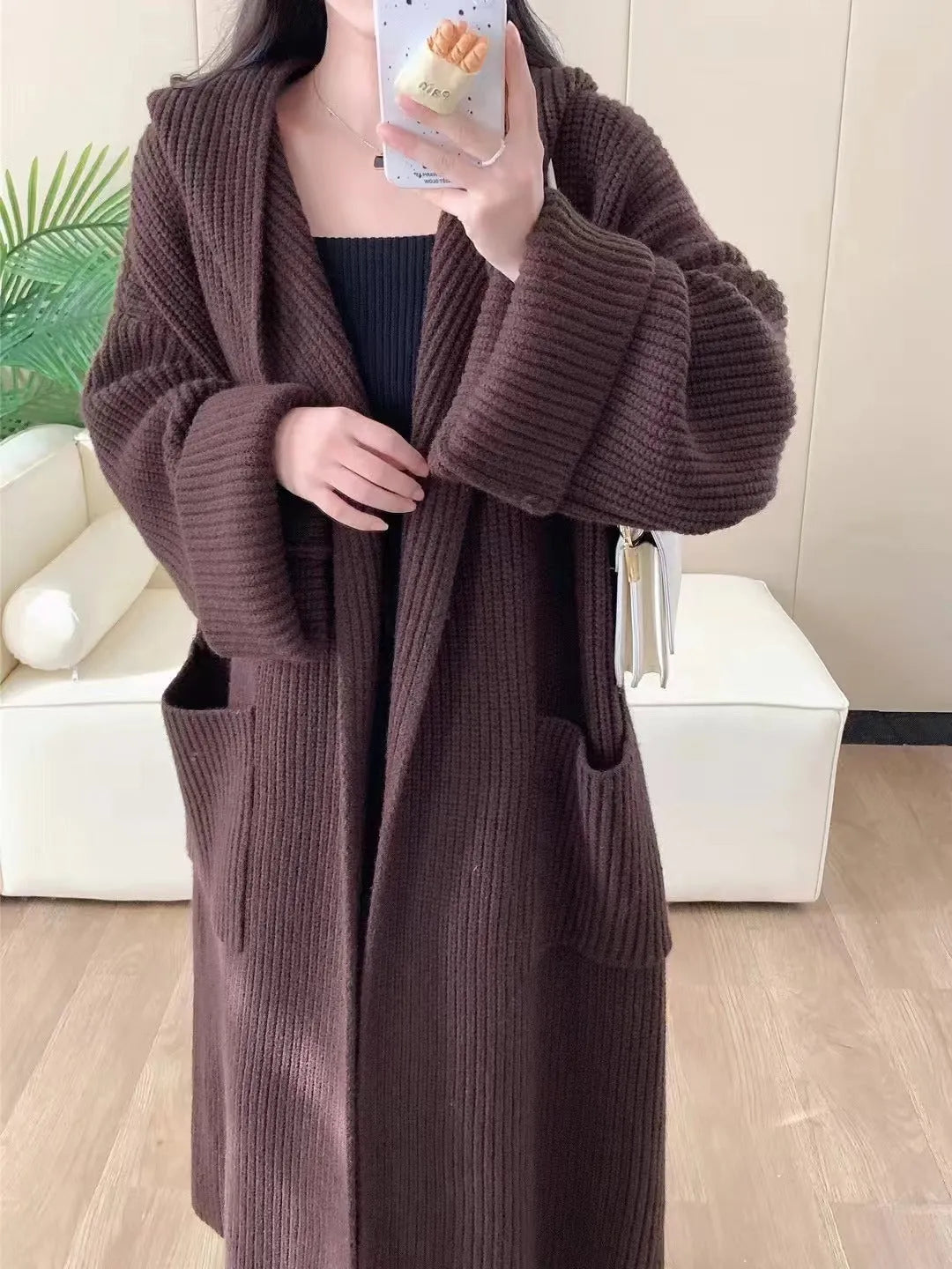 Loose hooded cardigan coat with raglan sleeves in acrylic fabric showing extended length