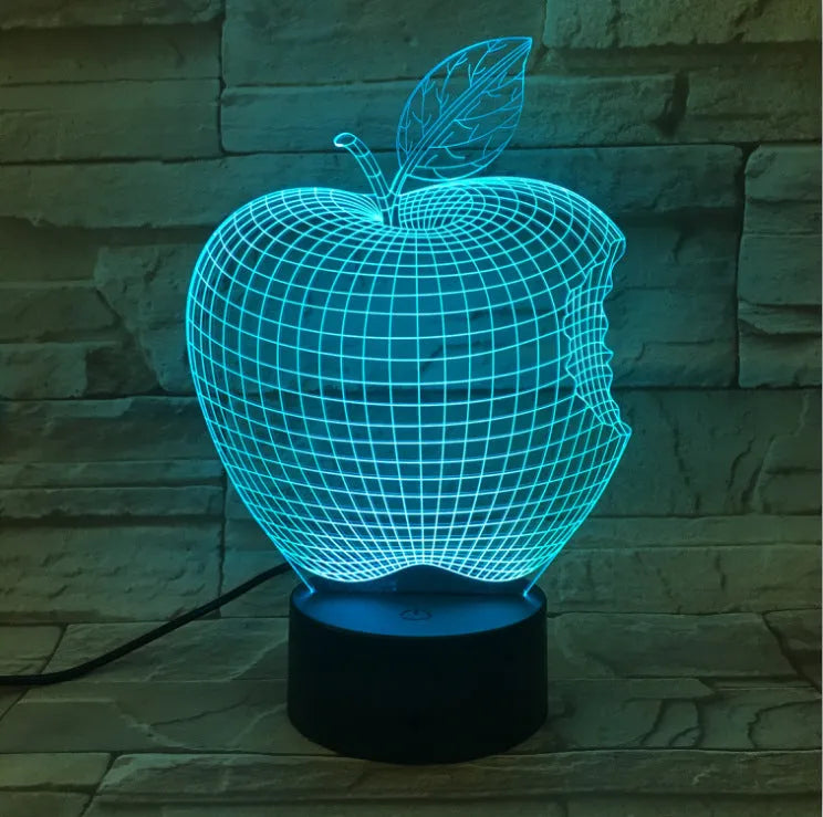 3D fruit-shaped decorative night light with colourful LED illumination on a table.