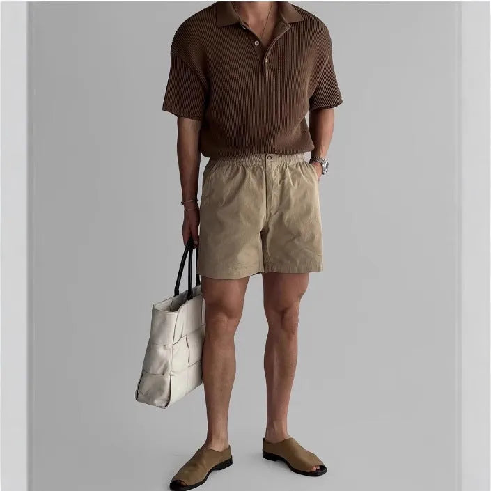 Men's loose-fit cotton sports shorts in black, shown on a white background.