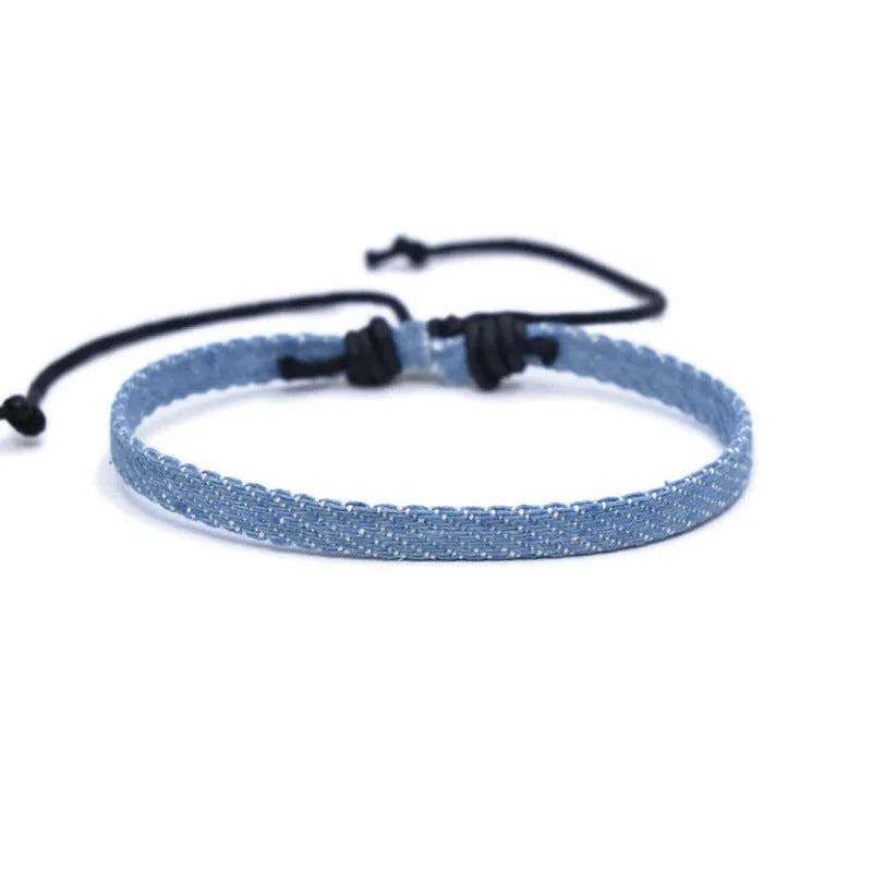 Denim fabric bracelet carrying strap with mixed materials and unisex design