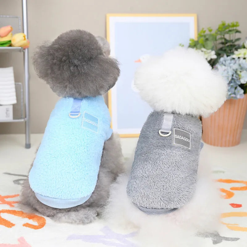Fluffy blue coral fleece pet jacket with multi-coloured pull ring fastening on a dog model.