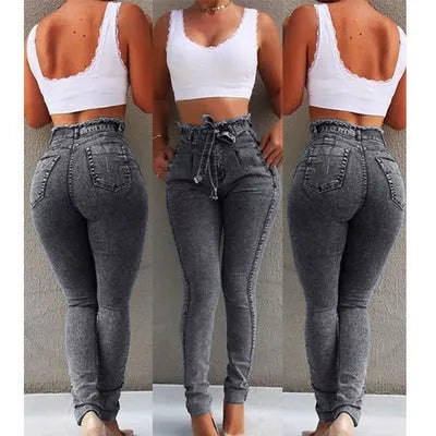 A pair of distressed grey fringed jeans made from Cowboy denim fabric on a neutral background.