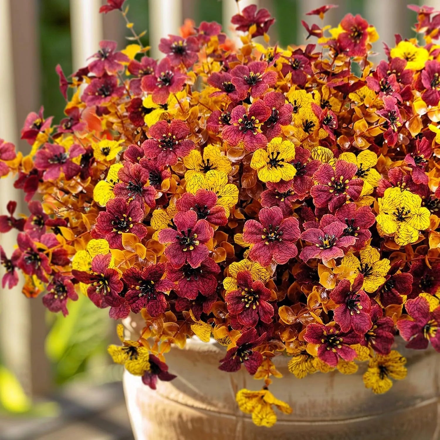 Artificial flower bouquet in autumn orange, red, and yellow colours for home or wedding decoration.