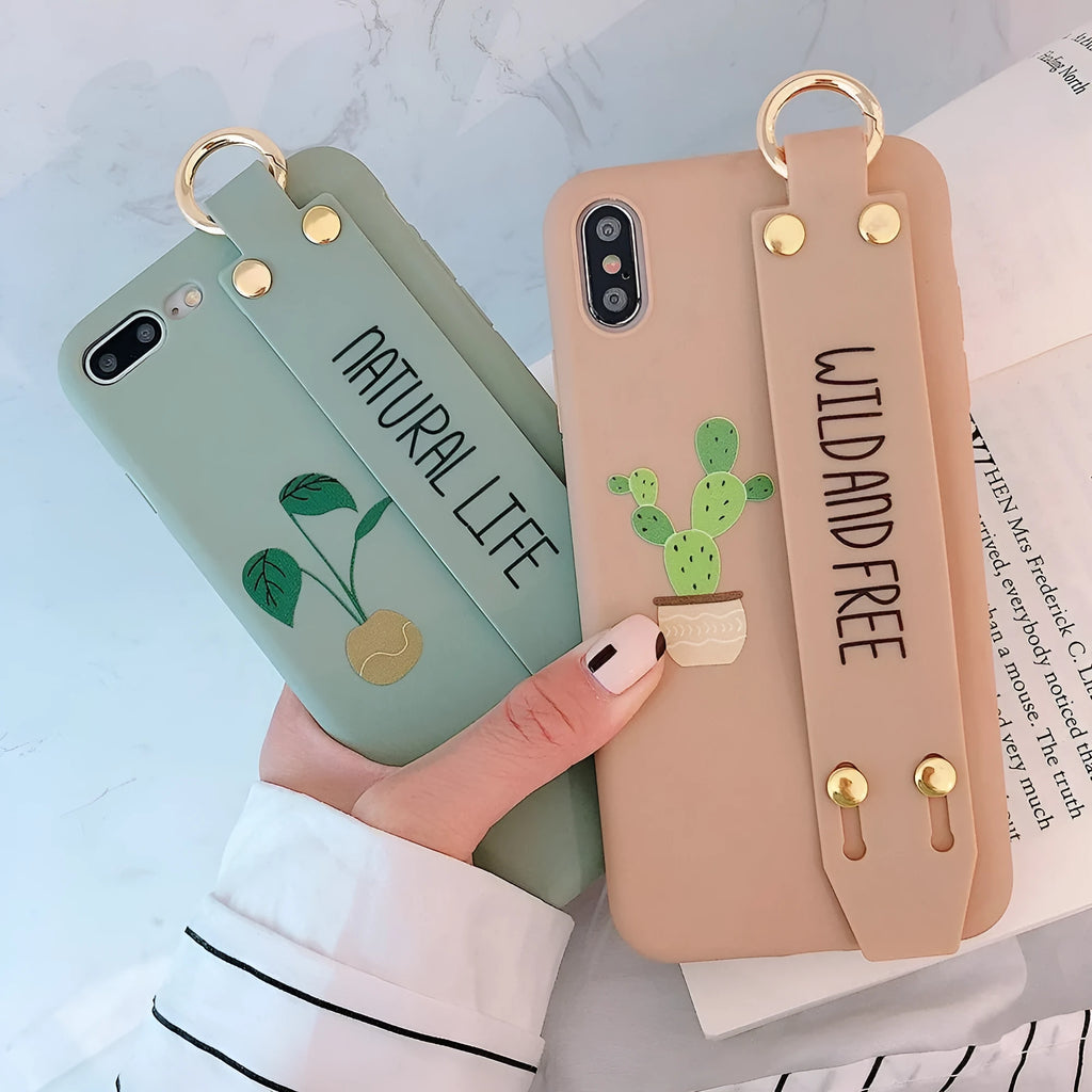 Green graffiti design iPhone wristband case with adjustable silicone strap attached to an iPhone model.