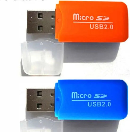Mini USB card reader with a 16GB MicroSD card and SD card adapter on a table.