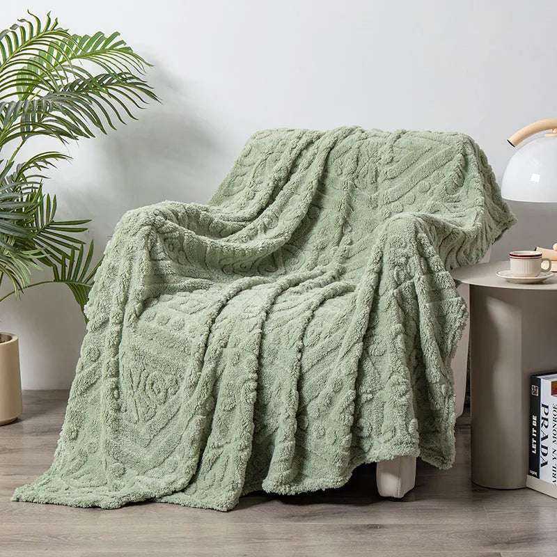 Shu cotton velvet jacquard sofa blanket in a solid colour draped over a modern sofa