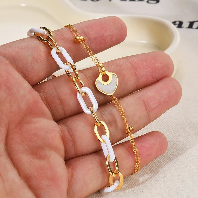 Double-layer heart-shaped stainless steel resin bracelet for women with electroplated finish.