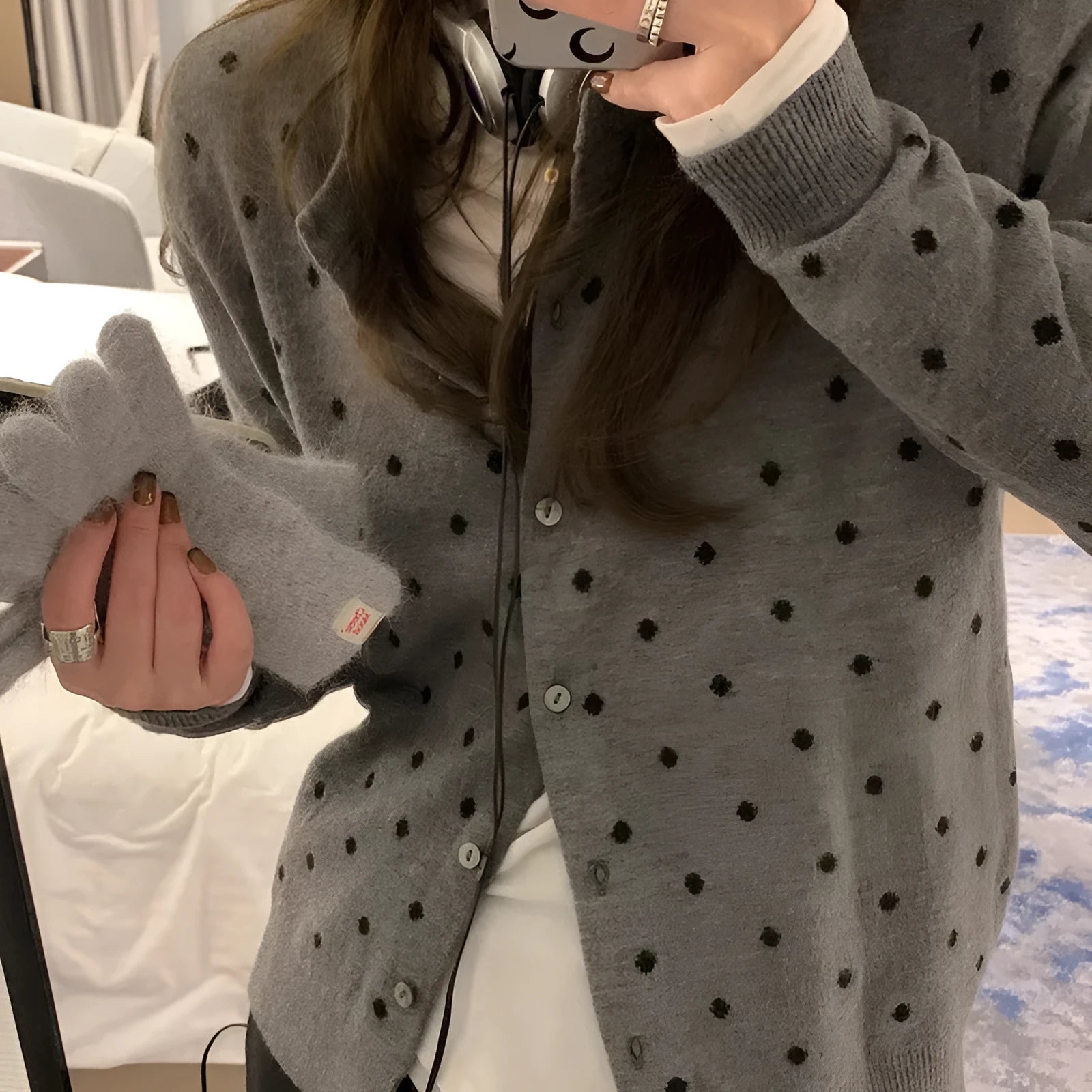 Women's grey dot knitted cardigan with long sleeves and crocheted flower detail