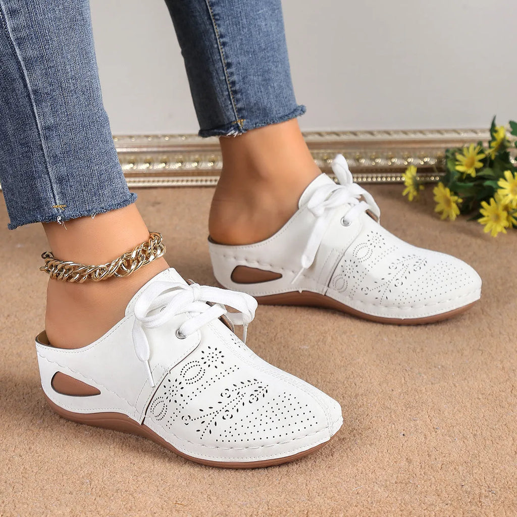 Women's suede lace-up wedge slippers in light grey, showing hollow-out design and rubber sole.